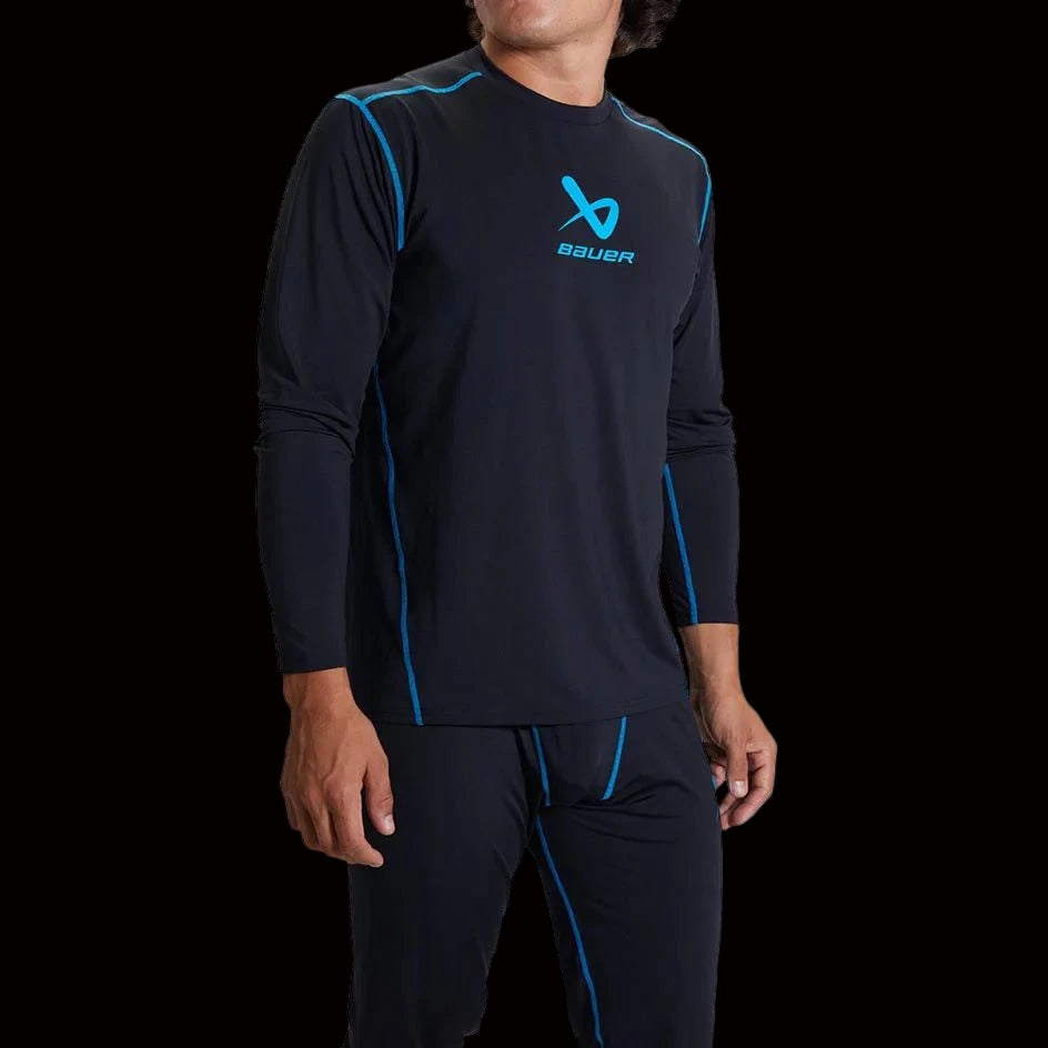 Man wearing Bauer Basic Base Layer LS Top S22 in black with blue accents.