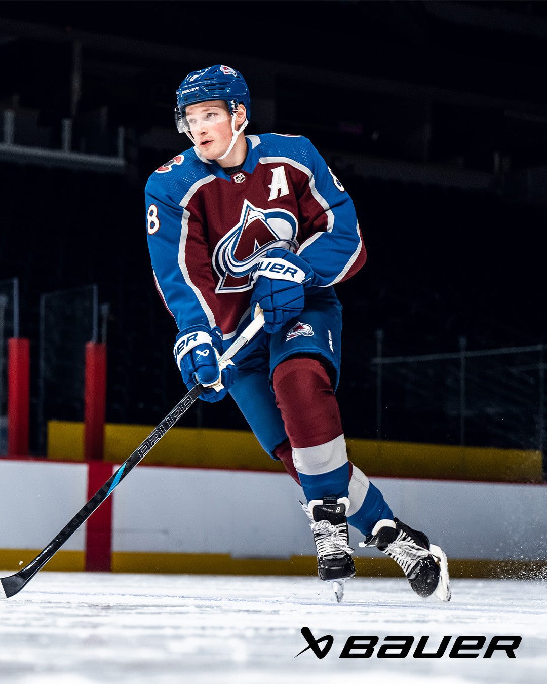 Elite hockey player using Bauer Nexus Tracer Hockey Stick on ice rink.