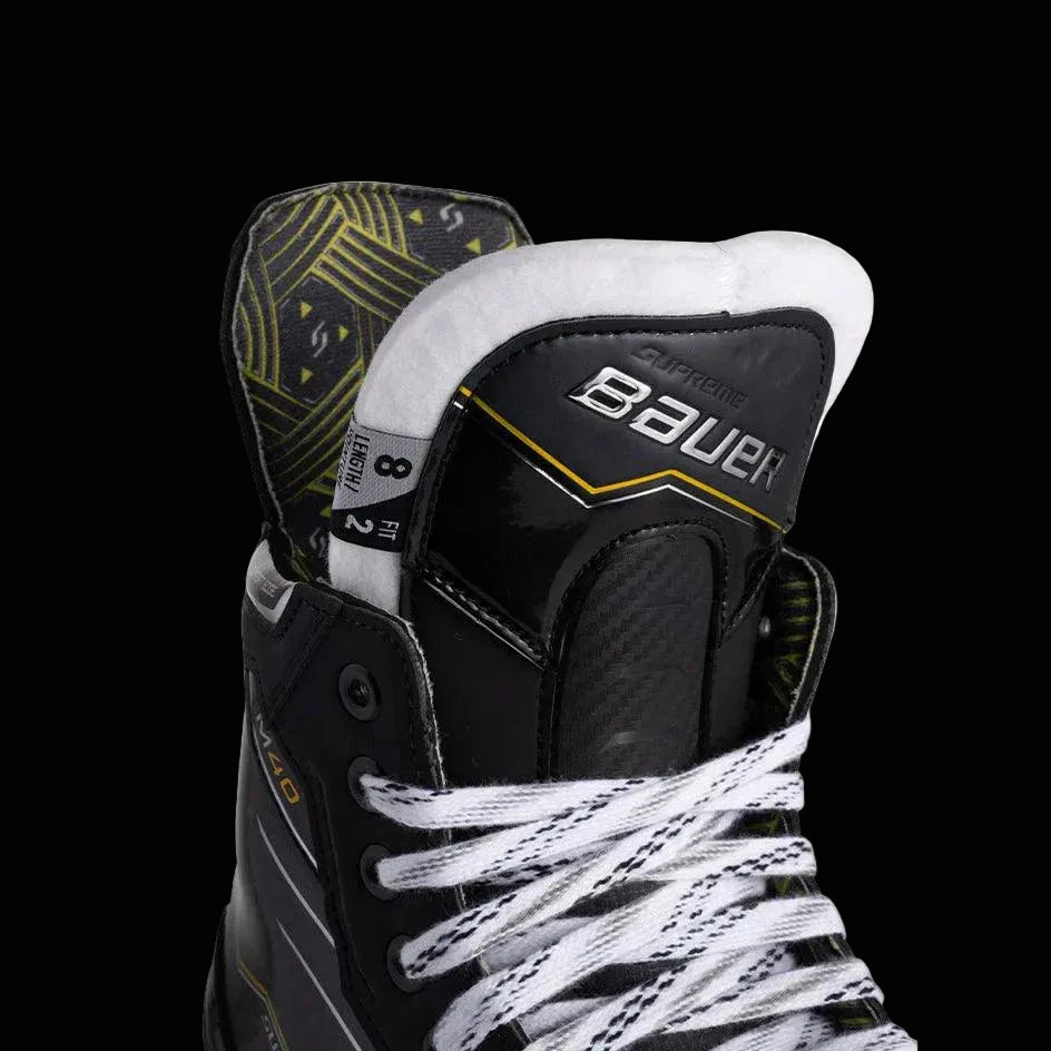 Close-up of Bauer Supreme M40 Ice Hockey Skates showcasing the pro stock felt tongue and CURV® composite boot construction.