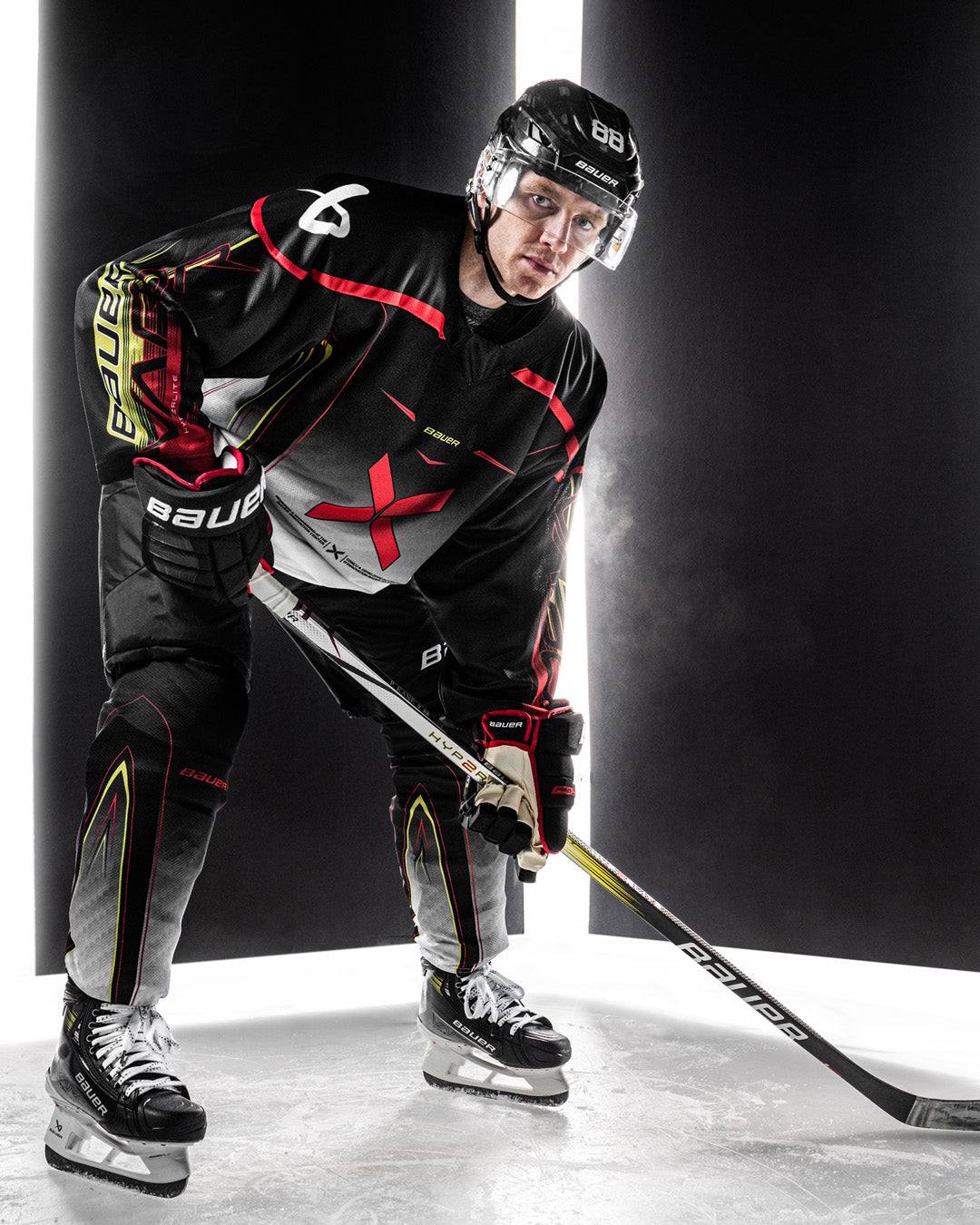 Bauer Vapor Hyperlite 2 Hockey Stick on ice with player in action.