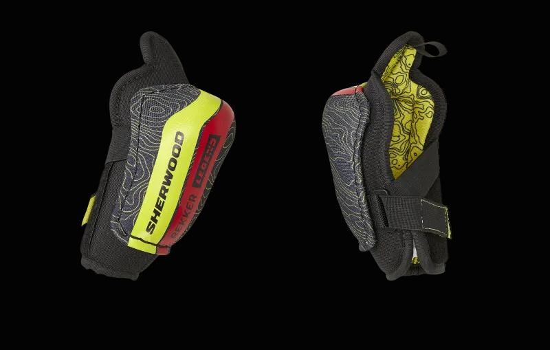 A pair of Sherwood branded youth elbow pads with a black base color and yellow and red accents.