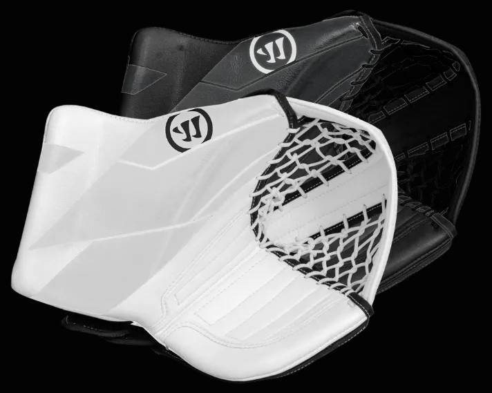 A black and white Warrior Ritual G7 YTH Catcher, a protective gear item for goalies in hockey, with a visible logo and netting.