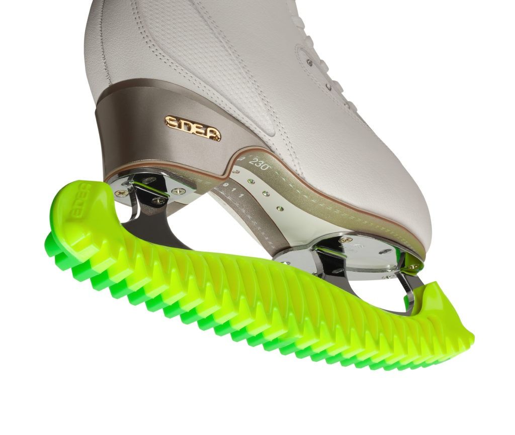 Edea E Guards on white skate showing green rubberized grip and blade protection.