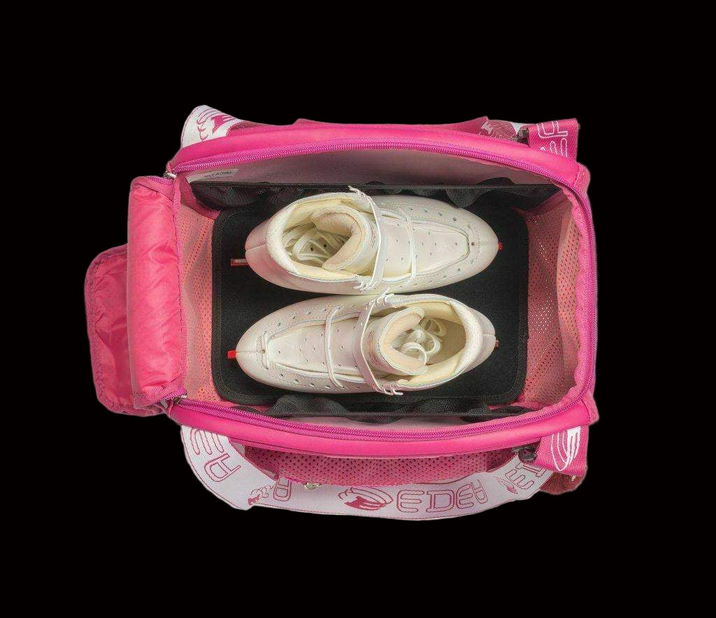 Top view of an open Edea Cube Skate Bag showing white skates inside with pink interior lining.
