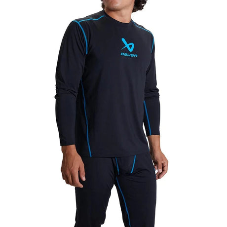 Man wearing Bauer Basic Base Layer LS Top S22 in black with blue accents.