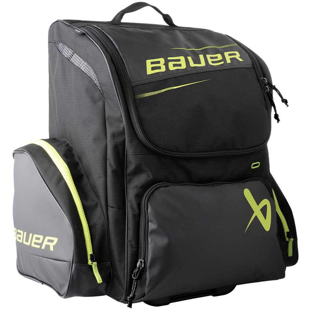 Bauer Elite Wheeled Backpack Junior S24 with wheels and backpack straps, large compartment, and multiple pockets.