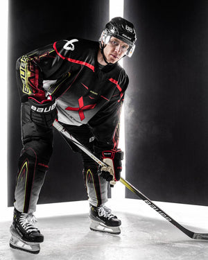 Bauer Vapor Hyperlite 2 Hockey Stick on ice with player in action.