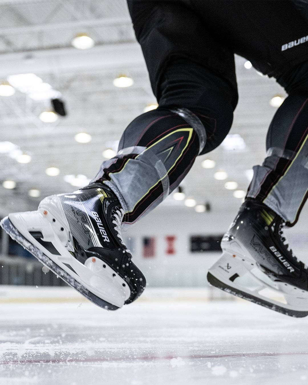 Bauer Vapor Hyperlite2 Skates on ice showcasing Powerfly holder and Hyperflex Technology.