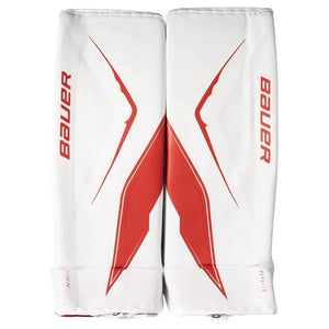 White hockey leg pads with red accents and Bauer branding on a white background