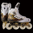 A pair of Mission Inhaler FS1 Inline Hockey Skates with white wheels, gold accents, and a gray and black color scheme.