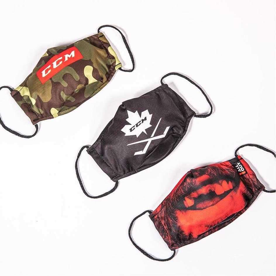 CCM Outprotect Face Mask with camo, black, and red designs, dual-layered polyester with filter sleeve.