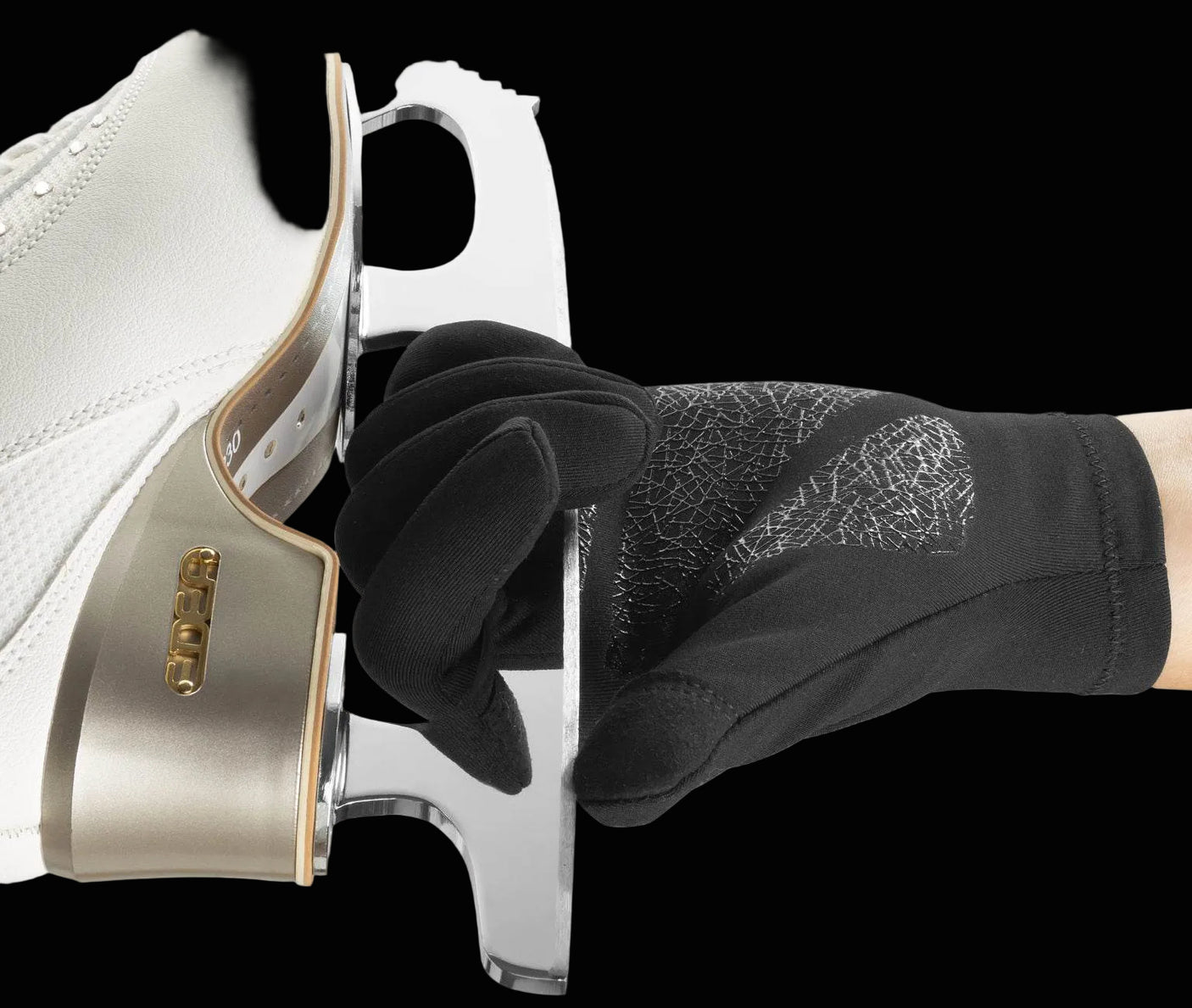 Edea E-Gloves Pro holding an ice skate blade with non-slip design, black color.