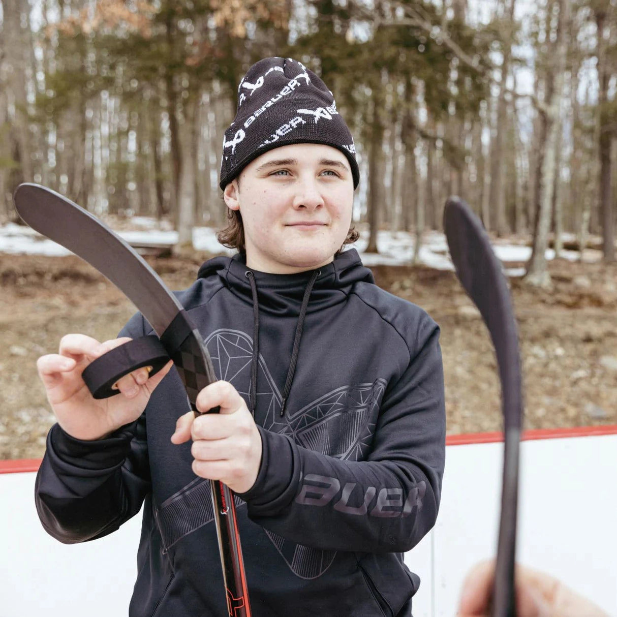 Bauer NE Overbrand Touque Knit Hat on person at outdoor rink.