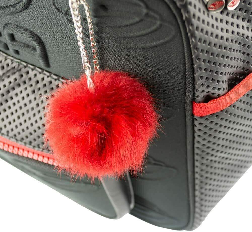 Edea Cube Skate Bag with red pom-pom detail, featuring ventilated polyester panels and embossed rigid sides.