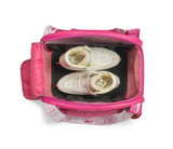 Top view of an open Edea Cube Skate Bag showing white skates inside with pink interior lining.